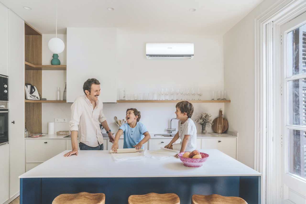 Father with two kids preparing pizza at home